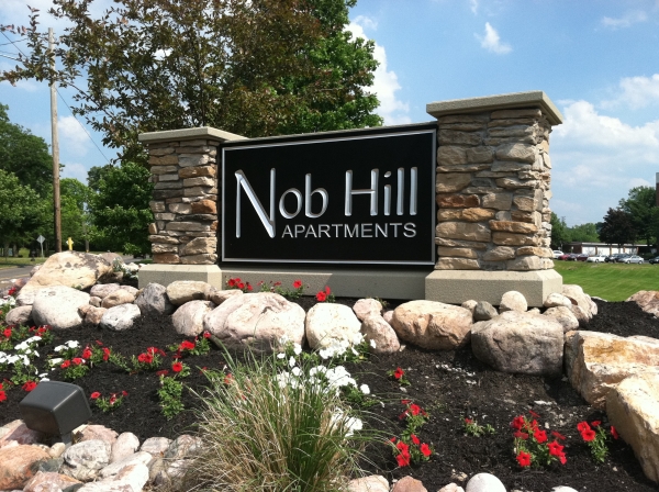 Architectural Signs :: Nob Hill Apartments:  This sign stands in front of the Nob Hill property entrance. It is a carved and painted HDU sign with stone pillars as a finish. :: Syracuse, NY Pittsburgh, PA